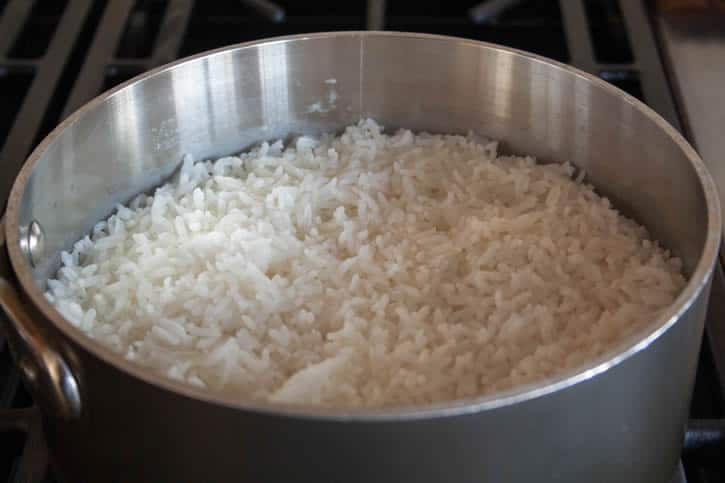 A closeup image of Perfect White Rice with finished cooking in a pot themerchantbaker.com