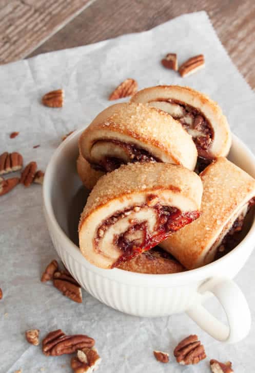 Raspberry Rugelach displayed in a cup on parchment paper by themerchantbaker.com