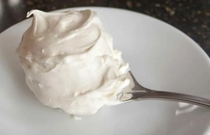 Whipped Cream Cream Cheese Frosting on a Spoon