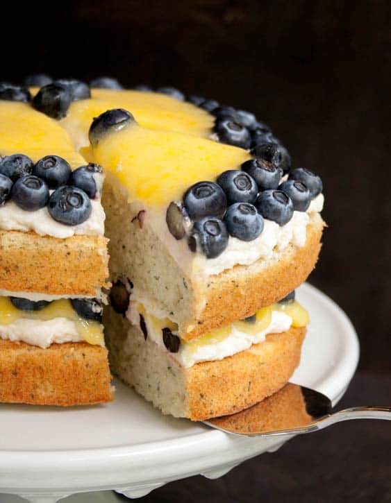 Slice of White Zucchini Cake with Whipped Vanilla Frosting, Blueberries and Lemon Curd