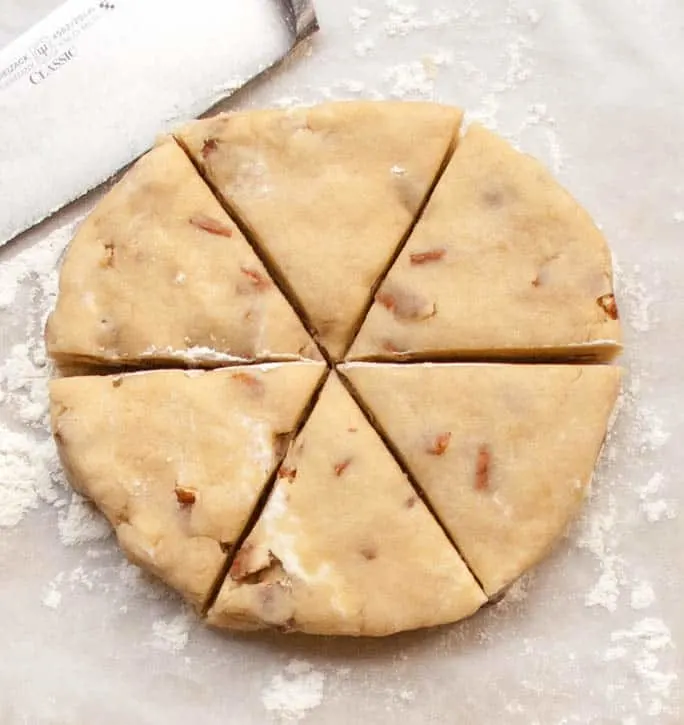 A circle of raw dough for Brown Sugar Butter Pecan Scones from themerchantbaker.com