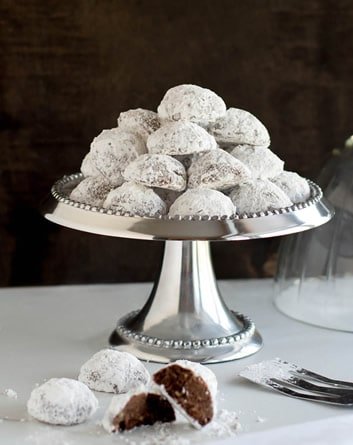 Minty Cocoa Snowballs. A chocolate peppermint twist on classic Russian teacakes with Andes mint chips. Make them with nuts or without!