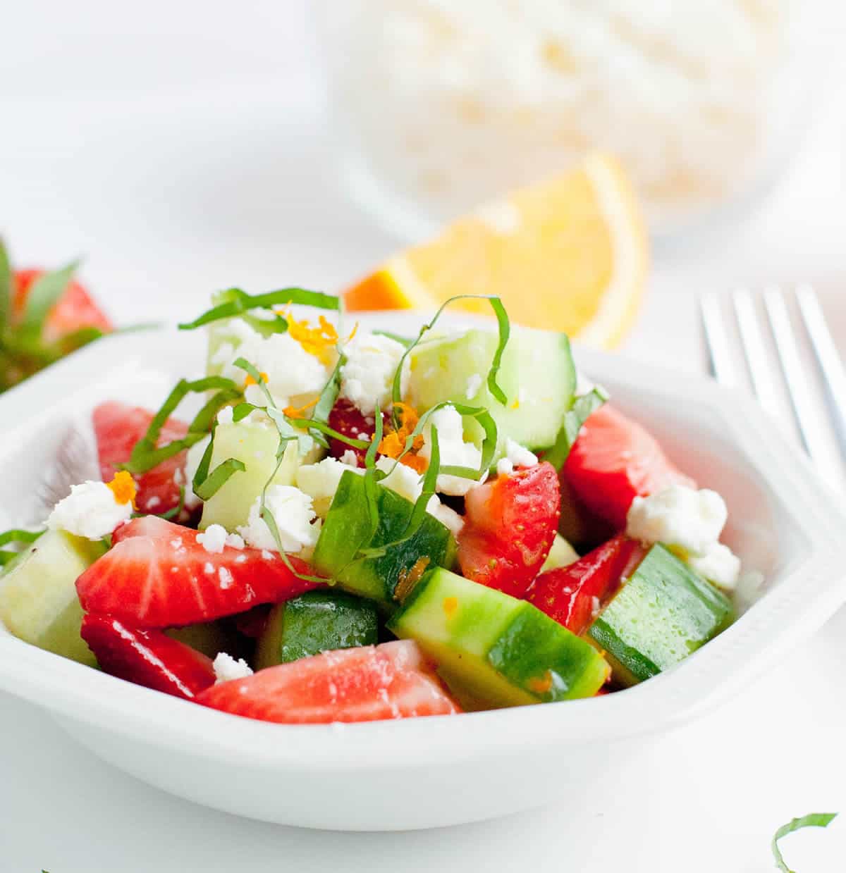 Strawberry Cucumber Salad-Fresh, sweet strawberries, crunchy cucumbers, zesty orange and briny feta. This is an easy salad to adapt to whatever fruit, cheese or veggies you may have on hand. Just mix them up and toss with the orange vinaigrette and you've got yourself one refreshing salad!