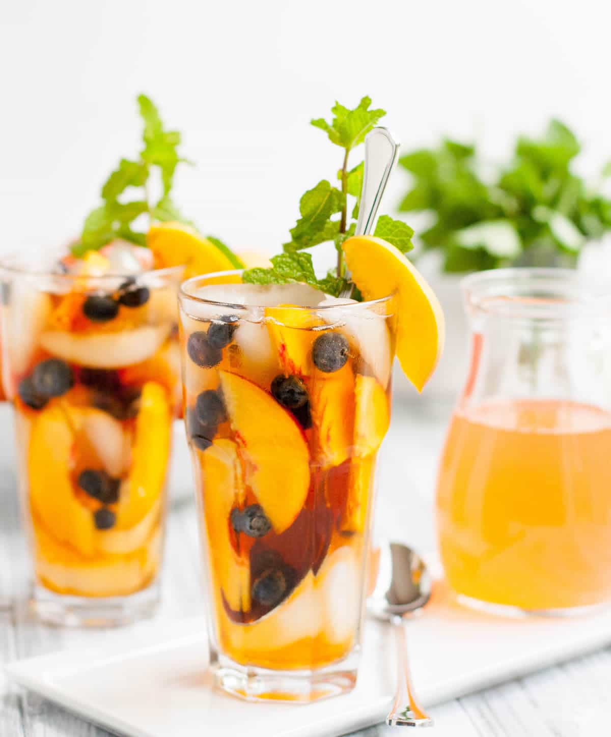 Fresh Peach Iced Tea, made with an easy peachy simple syrup with options to use as a clear syrup, as a syrup with the peaches in it or as a peachy puree.