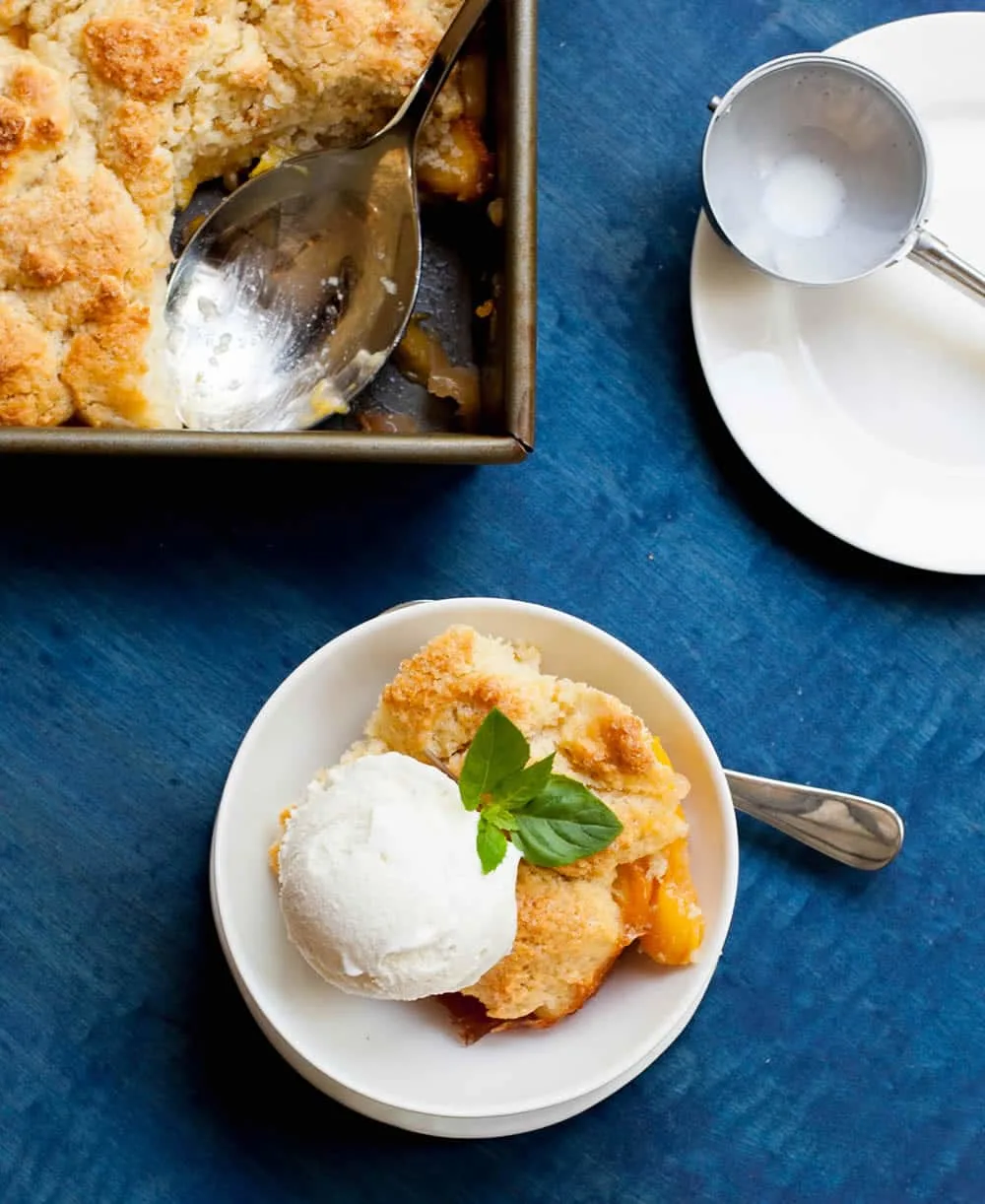 Georgia Peach Cobbler. Fresh peaches, lightly spiced and sweetened with two kinds of sugar, are baked under a delicious sweet biscuit topping!