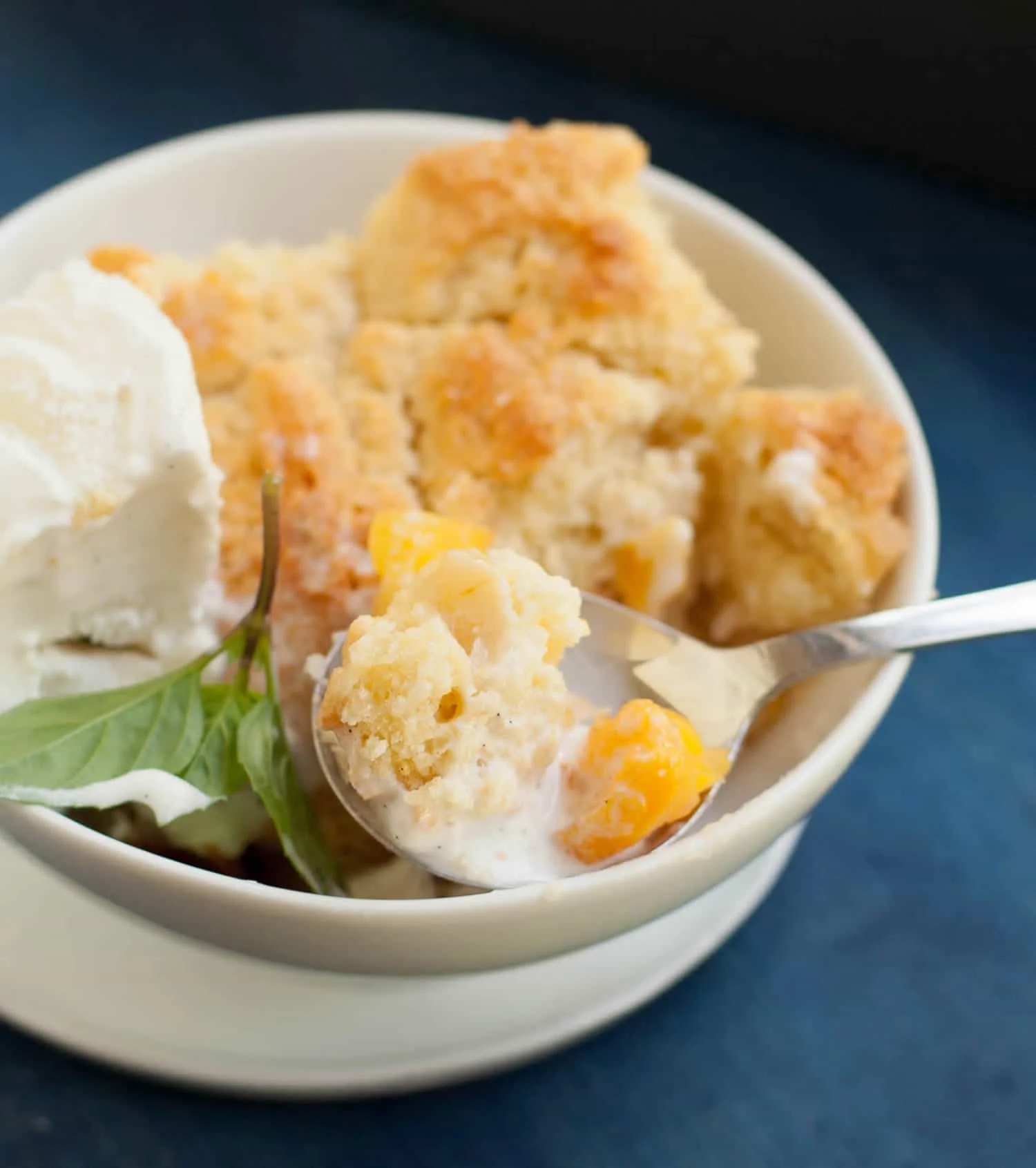Georgia Peach Cobbler. Fresh peaches, lightly spiced and sweetened with two kinds of sugar, are baked under a delicious sweet biscuit topping!