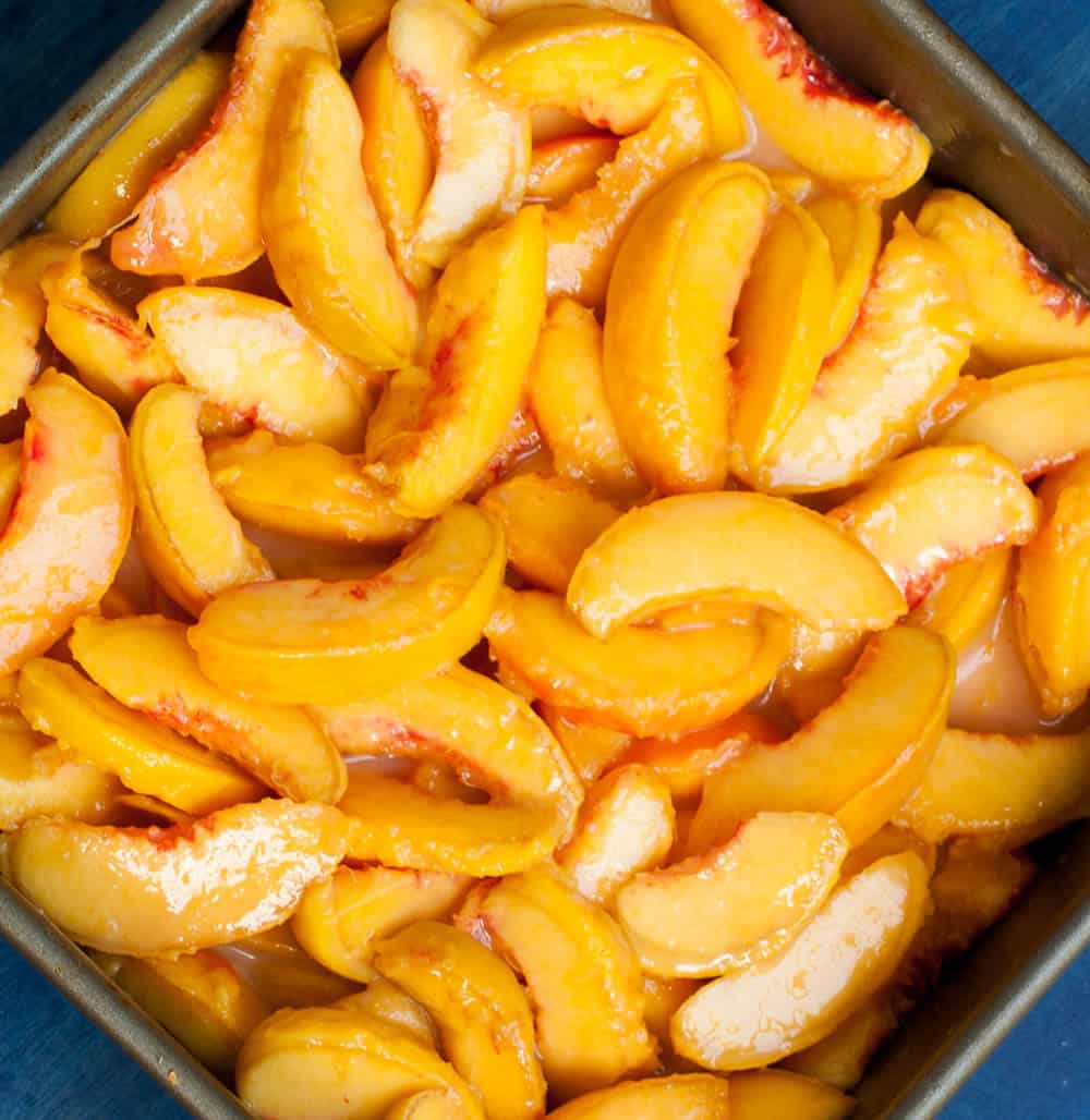 Georgia Peach Cobbler. Fresh peaches, lightly spiced and sweetened with two kinds of sugar, are baked under a delicious sweet biscuit topping!