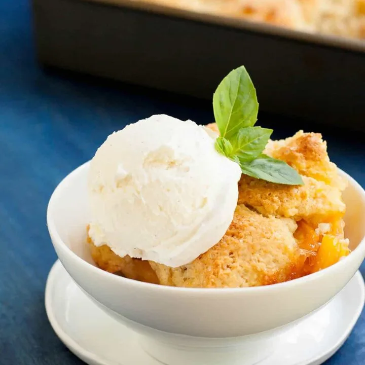 Georgia Peach Cobbler. Fresh peaches, lightly spiced and sweetened with two kinds of sugar are baked under a delicious sweet biscuit topping!