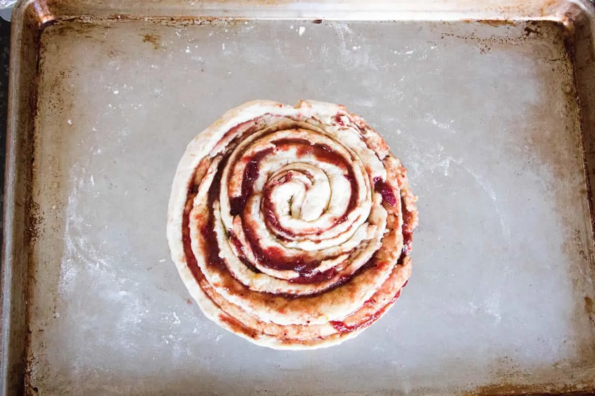 Cranberry Orange Sweet Roll. No yeast, no rising, no waiting! Just fluffy biscuit dough filled with cranberry sauce and flavored with fresh orange zest.