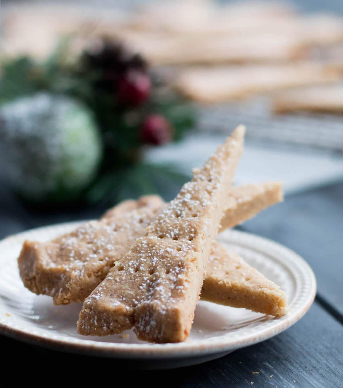 Three pieces of Spiced Shortbread on a white plate with by themerchantbaker.com