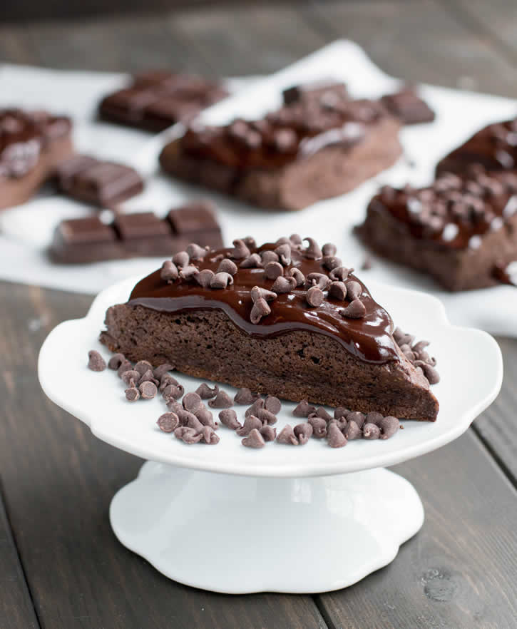 Dark Chocolate Fudge Scones are lightly sweetened, yet rich with dark cocoa, butter and cream, then topped with a dark fudgy ganache and mini chips.