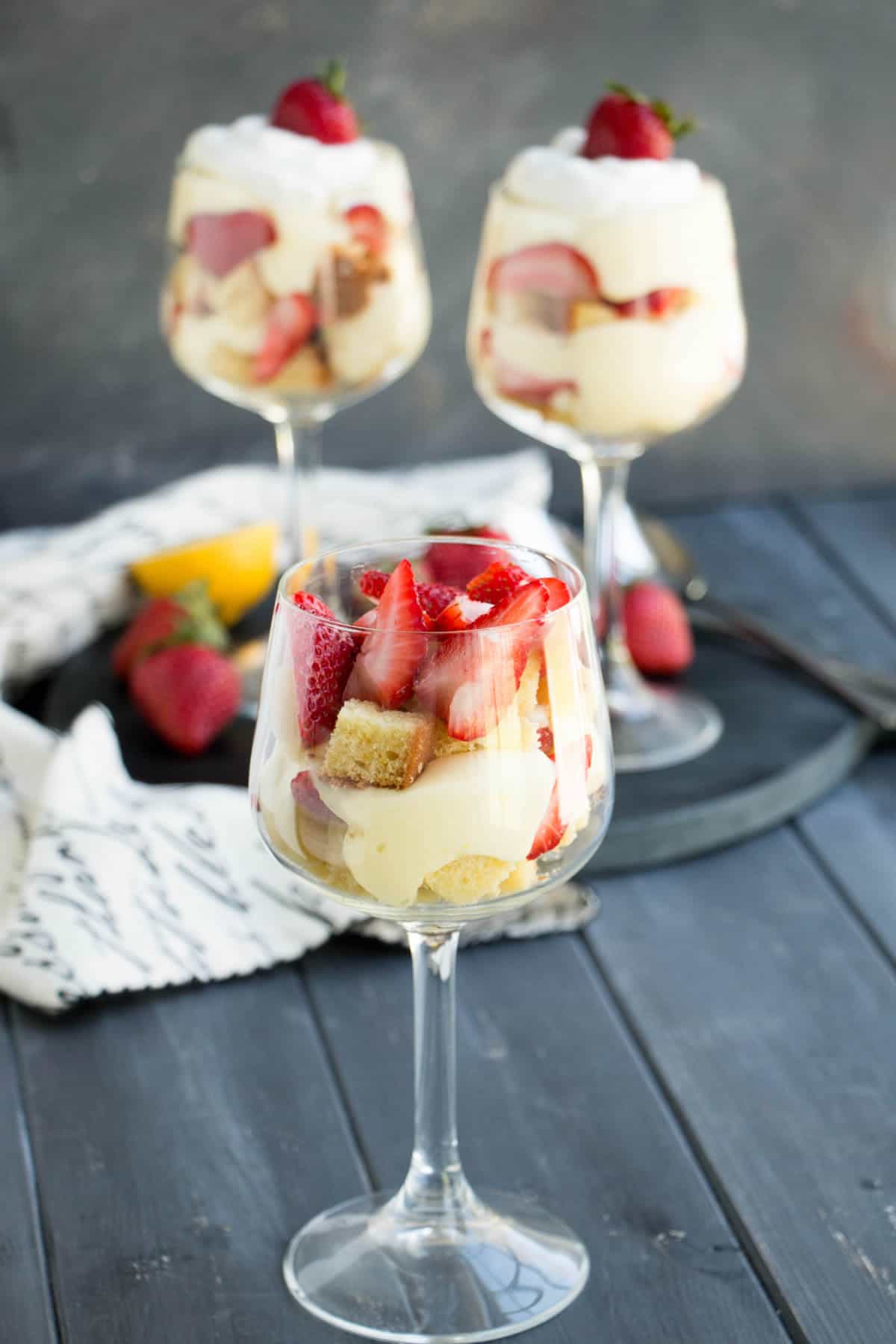 Strawberry Lemon Pound Cake Trifles. Triple citrus pound cake is layered with a no bake lemon curd cheesecake filling, fresh strawberries and whipped cream!