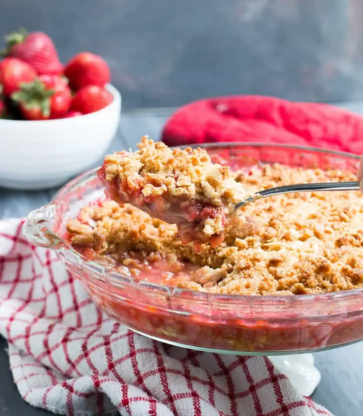 Strawberry Rhubarb Crisp. Fresh strawberries and tart rhubarb are topped with a sweet, buttery, crisp oatmeal topping for a delicious, easy to make dessert!