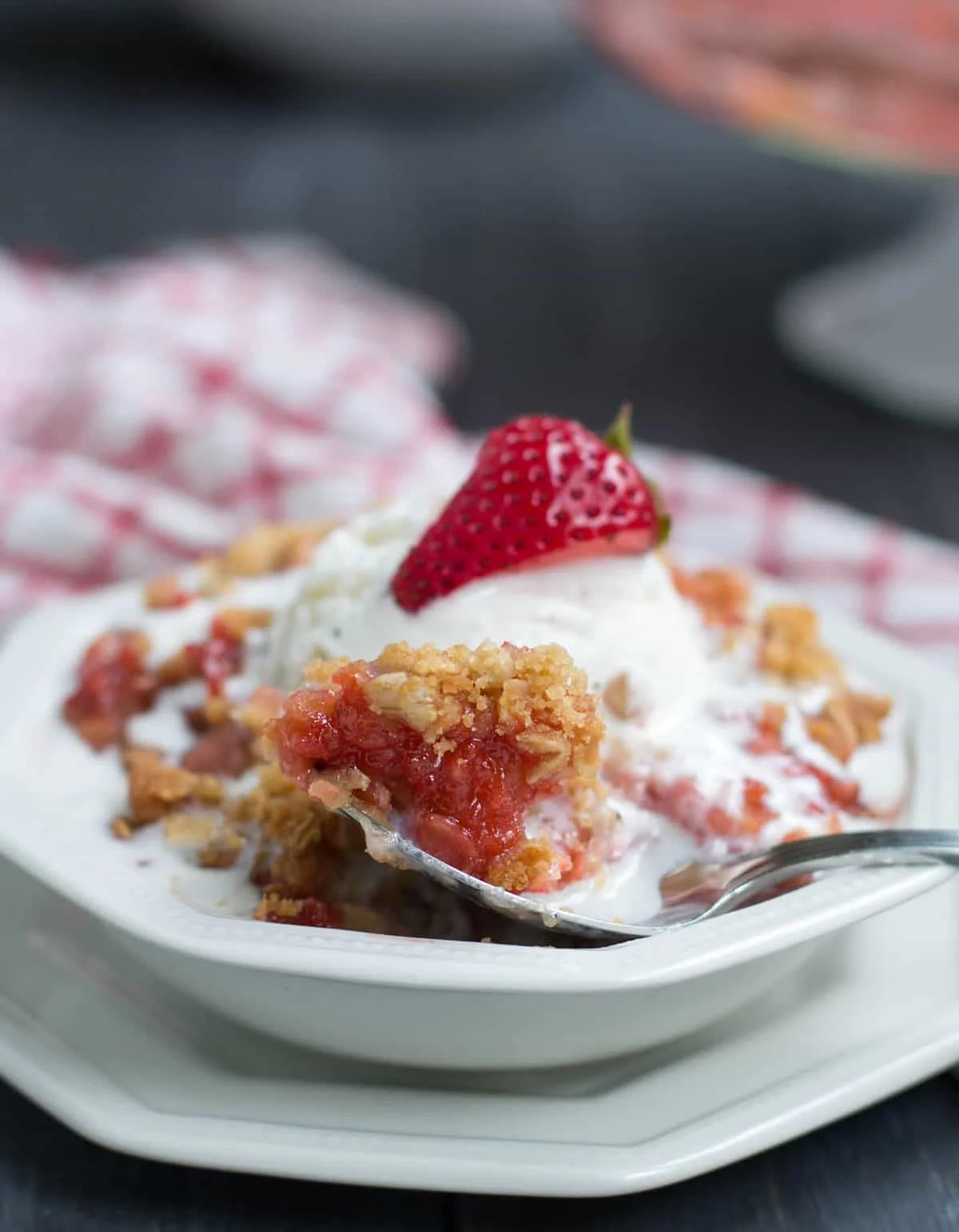 Strawberry Rhubarb Crisp. Fresh strawberries and tart rhubarb are topped with a sweet, buttery, crisp oatmeal topping for a delicious, easy to make dessert!