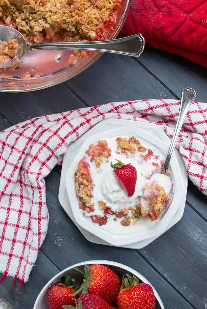 Strawberry Rhubarb Crisp. Fresh strawberries and tart rhubarb are topped with a sweet, buttery, crisp oatmeal topping for a delicious, easy to make dessert!