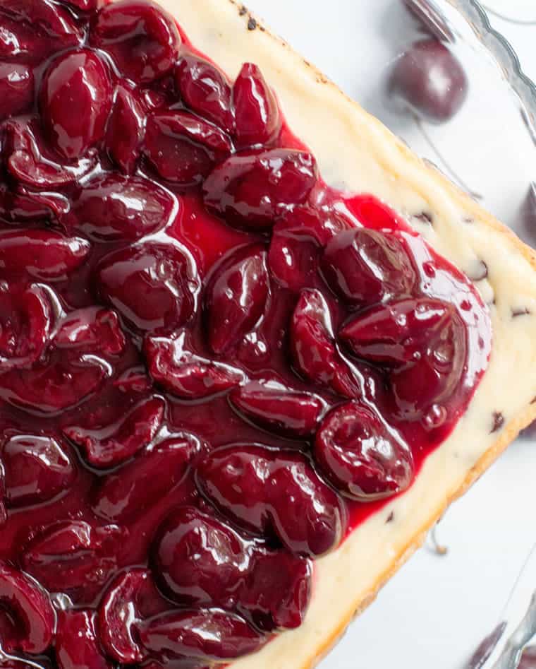 Chocolate Chip Cherry Cheesecake. A fresh sweet cherry sauce tops this easy to make cheesecake. A super fudgy cookie crust takes it over the top!