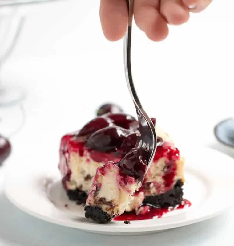 Chocolate Chip Cherry Cheesecake. A fresh sweet cherry sauce tops this easy to make cheesecake. A super fudgy cookie crust takes it over the top!