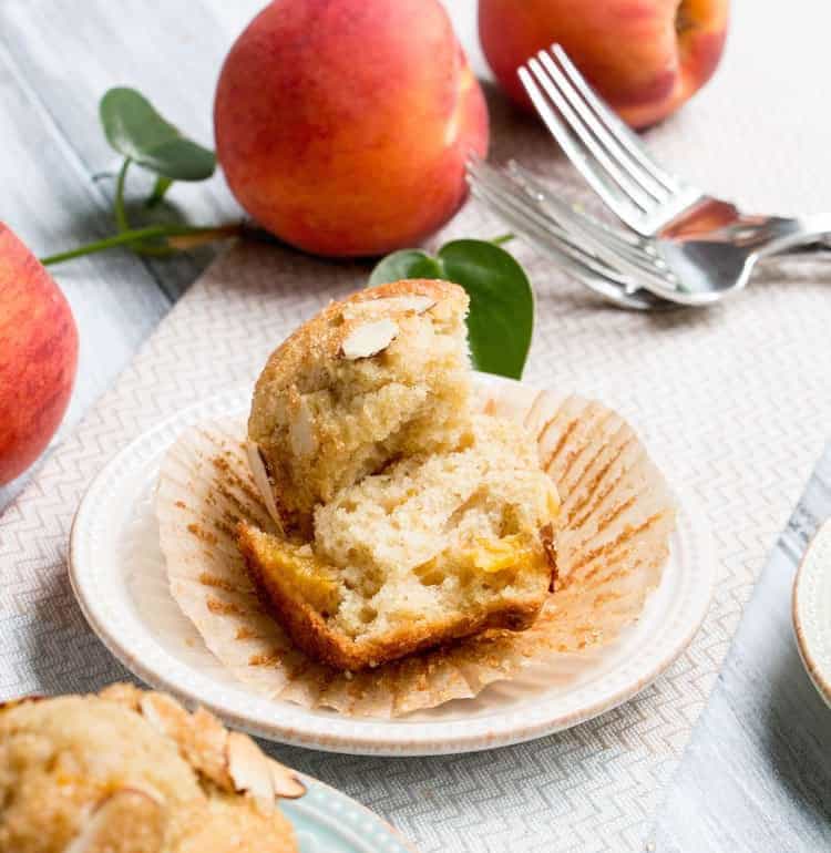 Peach Ricotta Olive Oil Muffins. Fluffy and full of fresh peaches, creamy ricotta and olive oil. A crunchy lid of almonds and raw sugar top them off!
