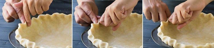 A photo showing how to flute the Easy All Butter Pie Crust in a pie pan from themerchantbaker.com