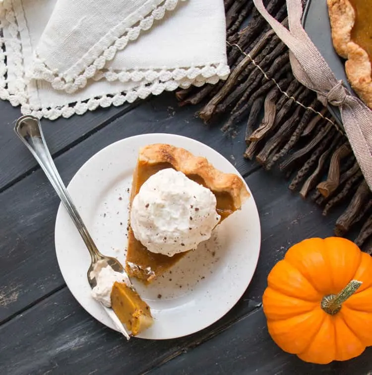 Pumpkin Pie baked with a touch of molasses, in an easy, all butter pie crust then topped with Brown Sugar Cinnamon Whipped Cream!