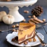 Triple Layer Pumpkin Nutella Cheesecake. Three flavors of cheesecake, a bonus layer of pure Nutella on the bottom, on a hazelnut speculoos cookie crust!