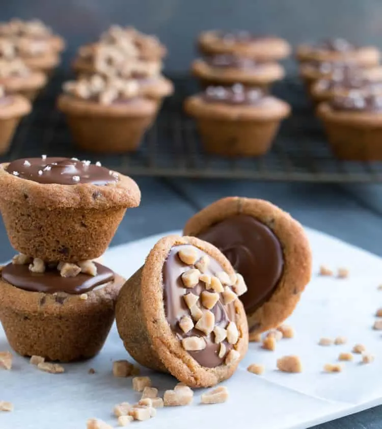 Chocolate Chip Cookie Peanut Butter Cups. Chocolate chip cookie cups filled with a creamy peanut butter filling and topped with melted chocolate.