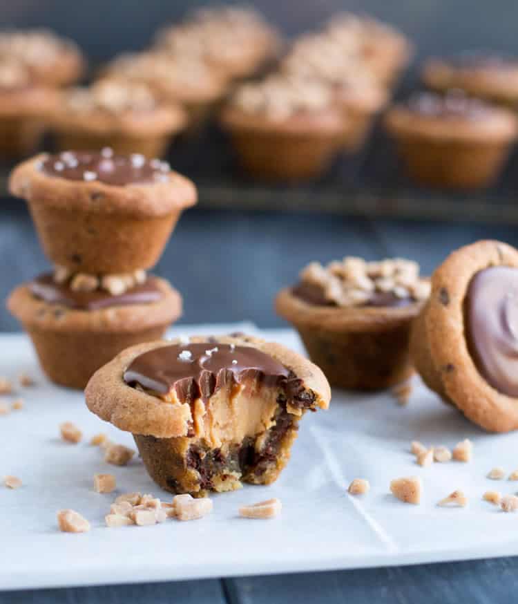 Chocolate Chip Cookie Peanut Butter Cups. Chocolate chip cookie cups filled with a creamy peanut butter filling and topped with melted chocolate.