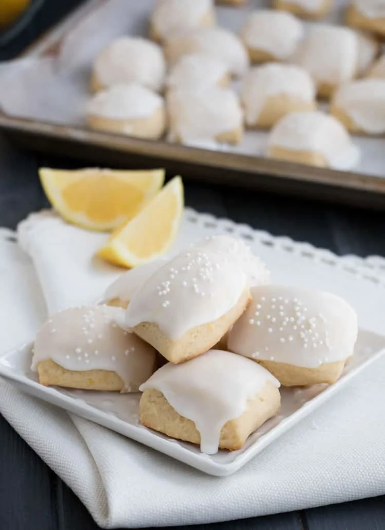 Iced Lemon Pillow Cookies. A soft, petite, pillow shaped cookie, flavored with fresh lemon zest and then coated in fresh lemon icing. A perfect tea cookie!