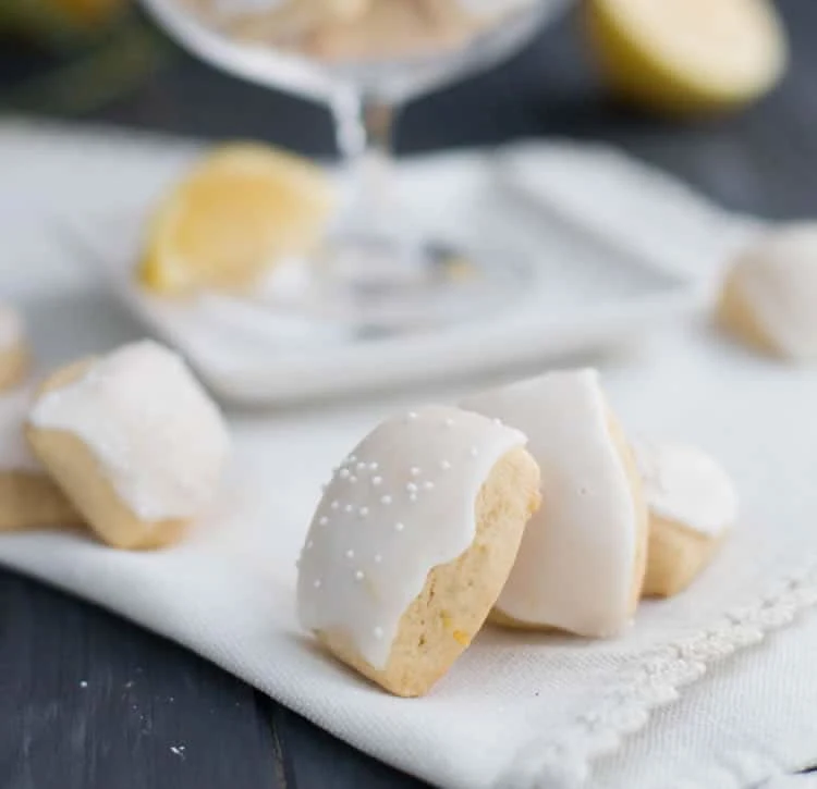 Iced Lemon Pillow Cookies. A soft, petite, pillow shaped cookie, flavored with fresh lemon zest and then coated in fresh lemon icing. A perfect tea cookie!