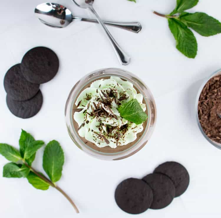 Mint Chocolate Pudding Parfaits. Easy chocolate pudding from scratch, topped with creamy chocolate mousse, layered with chocolate wafer cookies and topped with peppermint whipped cream!
