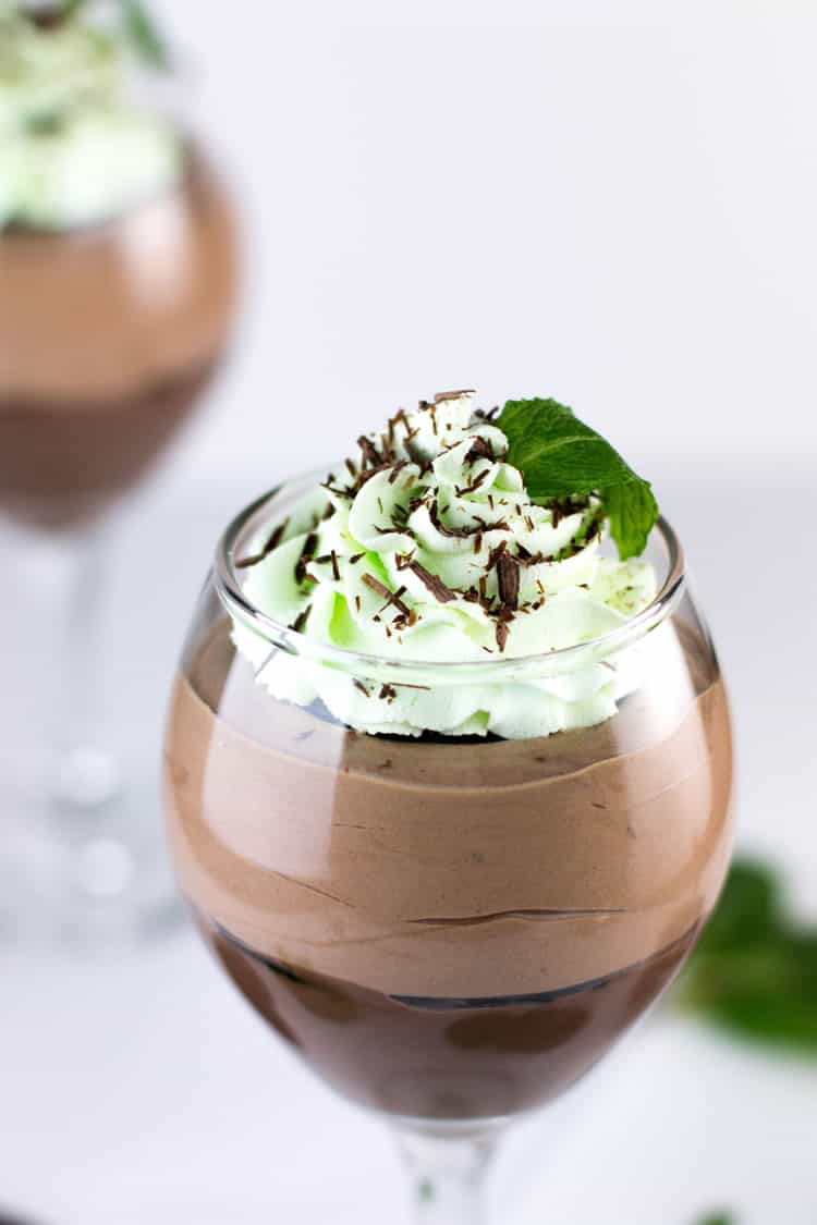 Mint Chocolate Pudding Parfaits. Easy chocolate pudding from scratch, topped with creamy chocolate mousse, layered with chocolate wafer cookies and topped with peppermint whipped cream!
