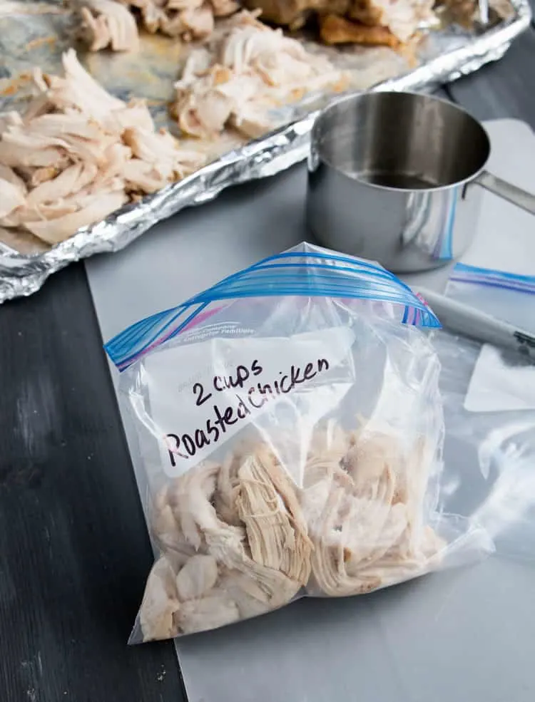 Showing 2 cups of Recipe Ready Roasted Chicken in a storage bag from themerchantbaker.com