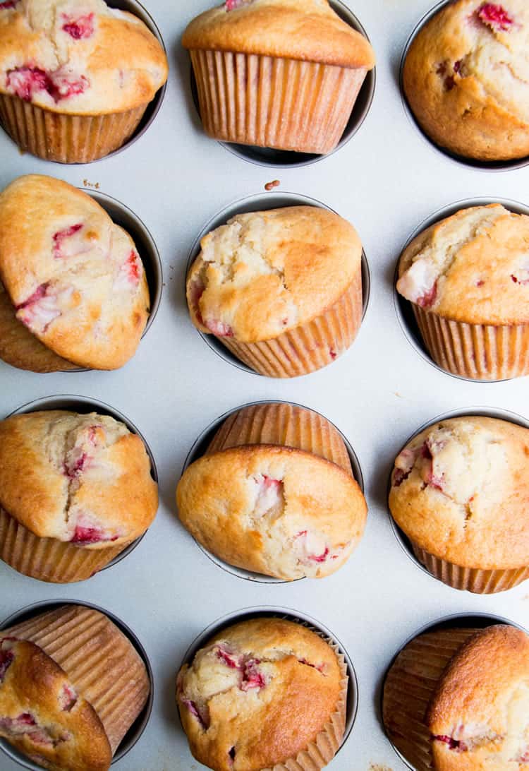 Fresh Strawberry Muffins titled out of cupcake tin to cool from themerchantbaker.com