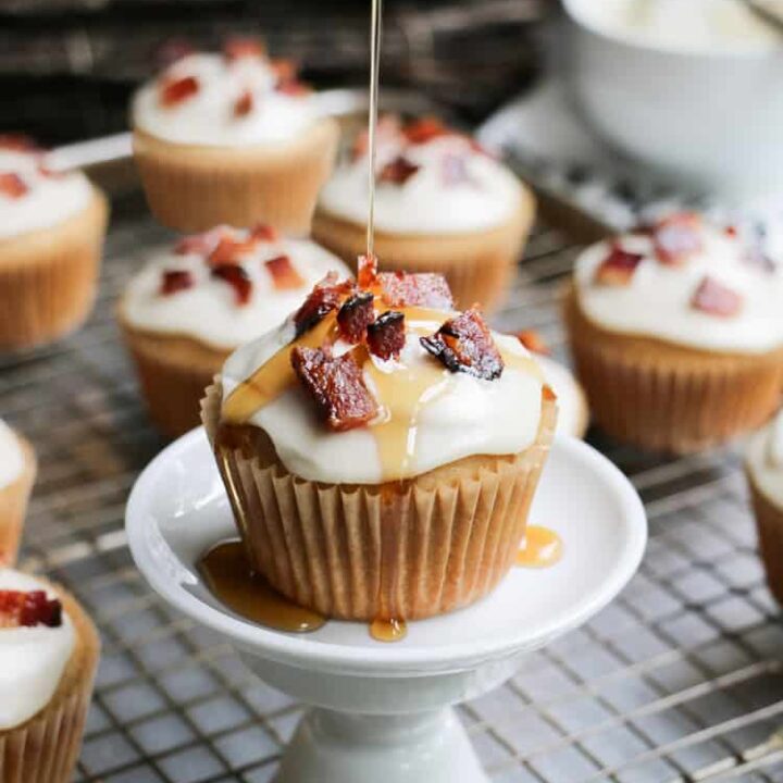 Glazed Bacon Maple Syrup Muffins, made with pure maple syrup and butter, topped with glazed bacon. Perfect sweet and savory treat for breakfast or brunch!