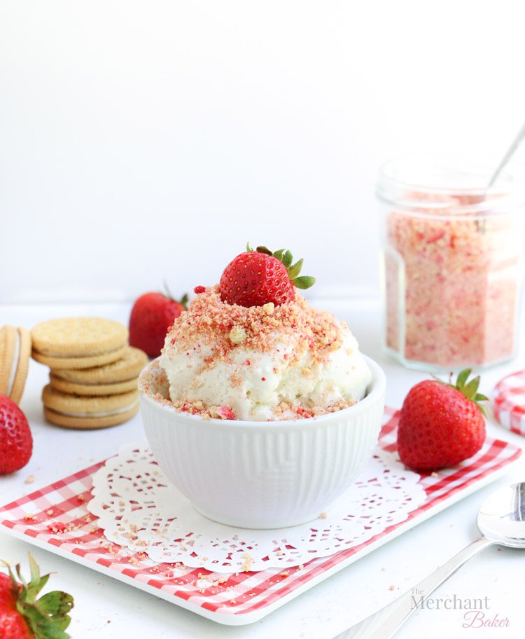 Strawberry Shortcake Ice Cream Topping on vanilla ice cream in a bowl with strawberry on top from themerchantbaker.com