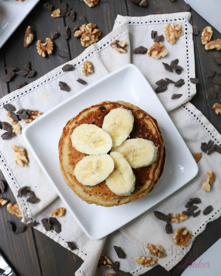 Overhead view of sliced bananas on top of a stack of Oatmeal Chocolate Chip Banana Pancakes