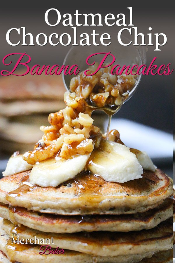 Pinterest Image Walnut syrup being ladled over a stack of Oatmeal Chocolate Chip Banana Pancakes topped with sliced bananas from themerchantbaker.com