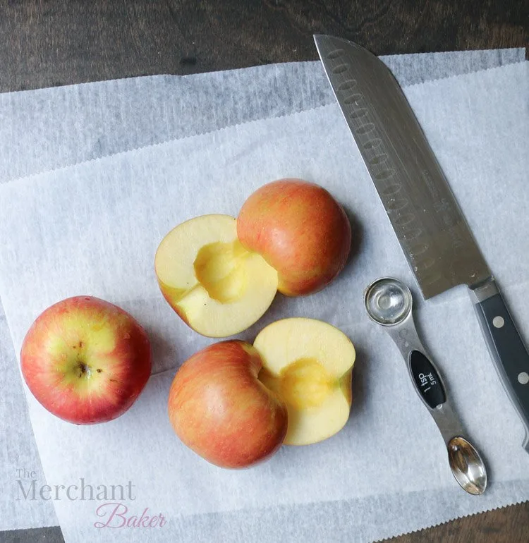 Sliced apples on parchment paper for Baked Apple Oatmeal by themerchantbaker.com