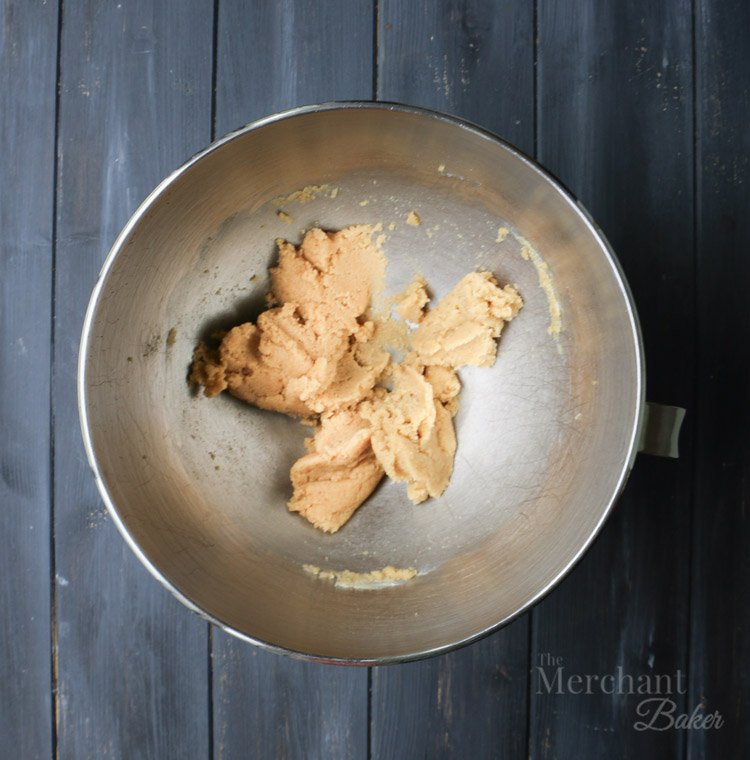 An overhead view of batter in a bowl to make Brown Sugar Cinnamon Whipped Cream Cream Cheese Frosting by themerchantbaker.com