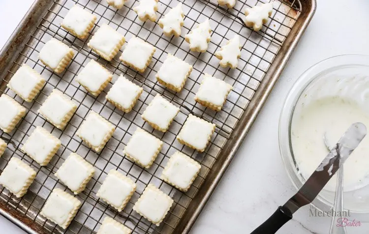 overhead view of iced cookies on a cooling rack.