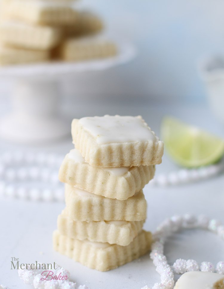 Close up of a Stack of iced lime meltaway cookies cut into square shapes