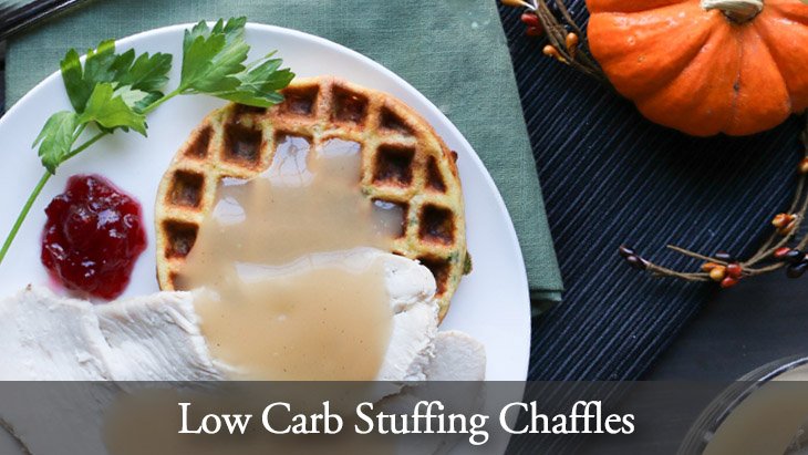 Low Carb Stuffing Chaffles on a white plate with turkey, gravy and cranberry sauce by themerchantbaker.com