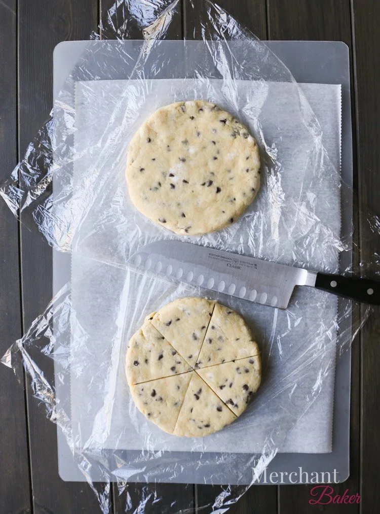An overhead photo of two raw scone forms showing the shape and cut lines by themerchantbaker.com