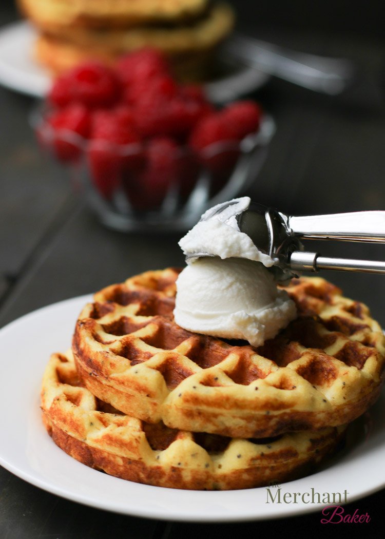 Placing a scoop of ricotta cheese on to a stack of two chaffles