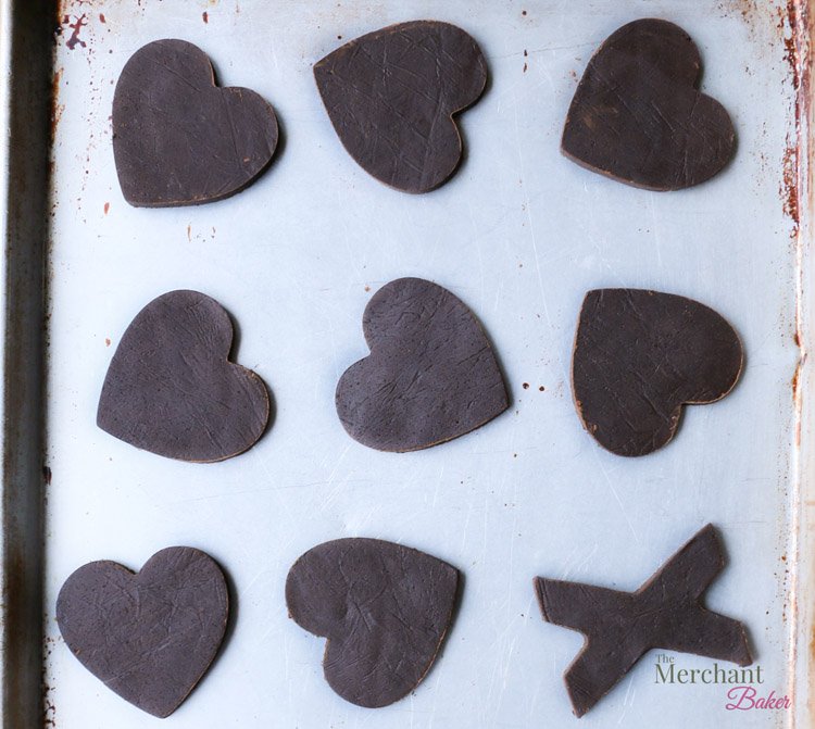 Heart shapes from unbaked Chocolate Sugar Cookie dough from themerchantbaker.com