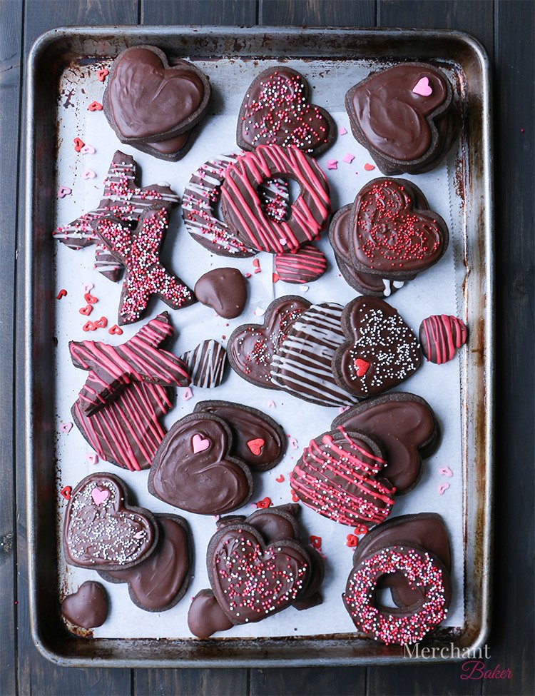 Overhead photo of decorated Chocolate Sugar Cookies on a sheet pan by themerchantbaker.com