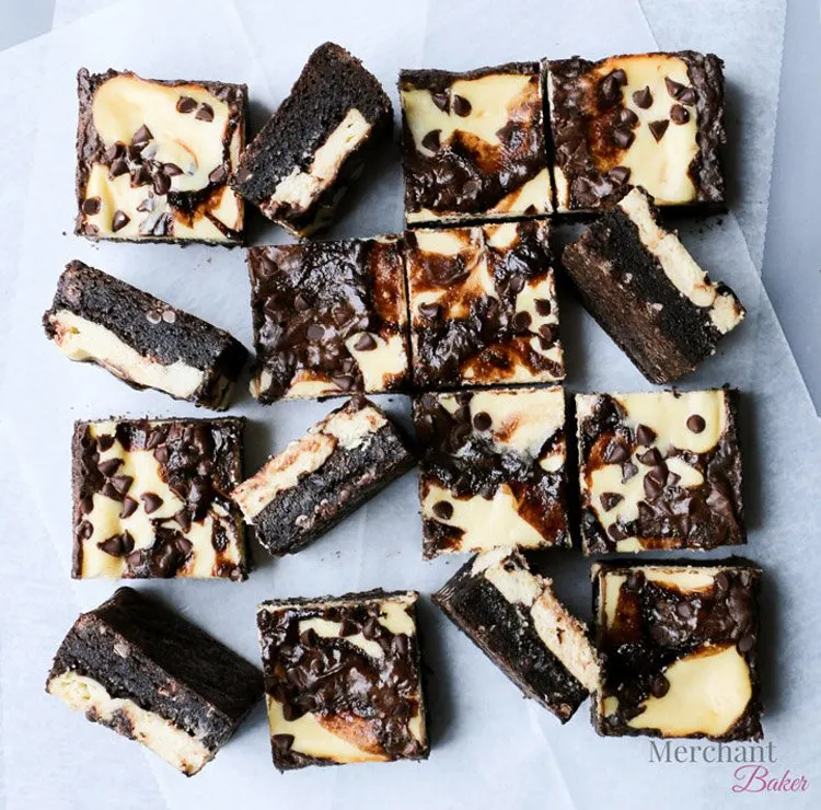 Pan sized Irish Cream Cheesecake Brownies cut into smaller squares by themerchantbaker.com