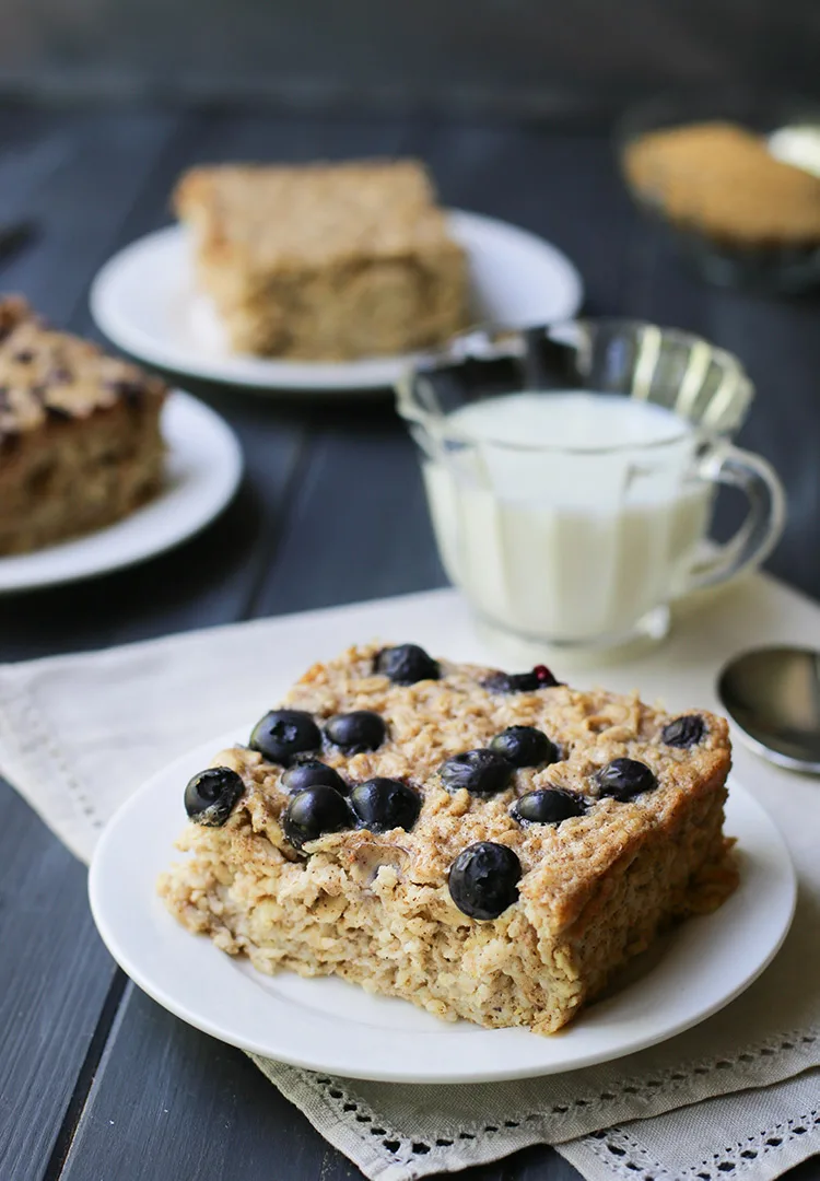 Square of baked oatmeal with blueberries baked on top