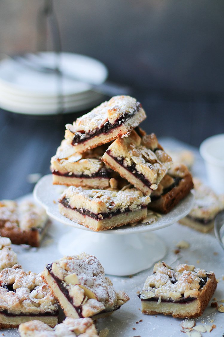 Cherry Crumb Bars piled on a small pedestal plate