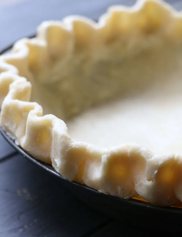 Close up of tall crimped unbaked pie crust edges